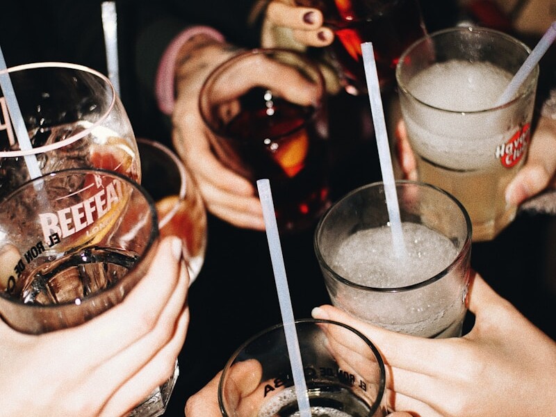 a group of people holding glasses with drinks in them